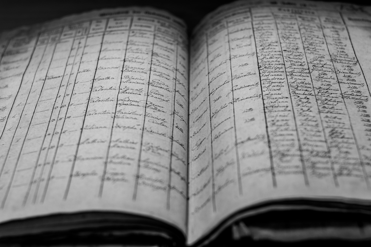Notebook and archive materials on a wooden surface